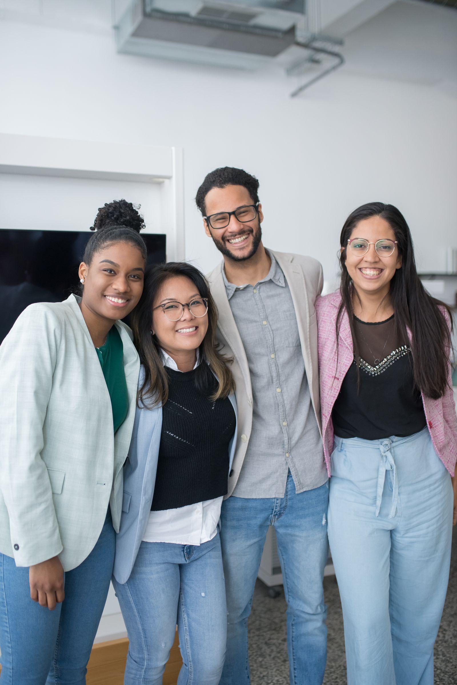 Diverse young professionals smiling together in an office