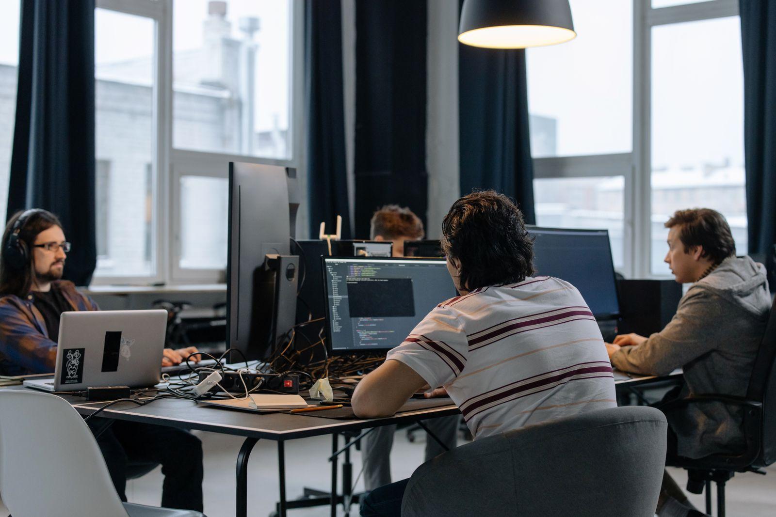 Technology team collaborating on a localization program in a modern office