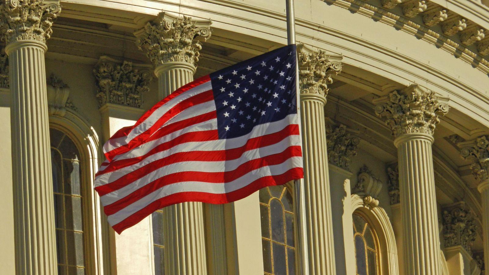 American flag flying in front of the U.S. Capitol